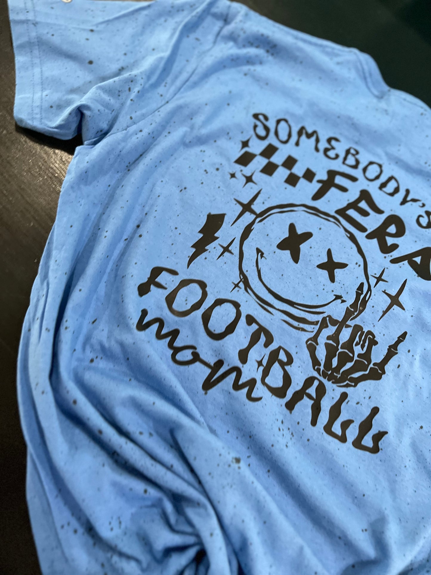 "Somebody's Feral Football Mom" Speckled T-shirt